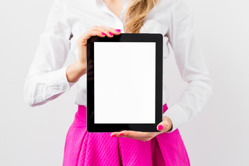 Woman holding ipad with empty white screen vertically