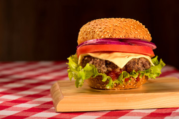 Tasty burger with flag, french fries and beverage