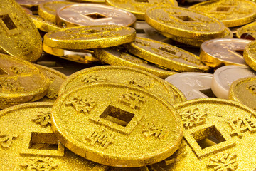 Chinese coins of gold color shot close-up cues