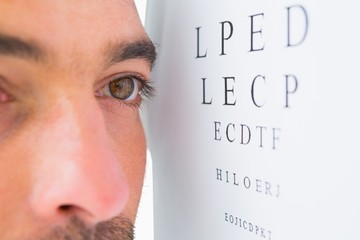 Focused man on eye test letters