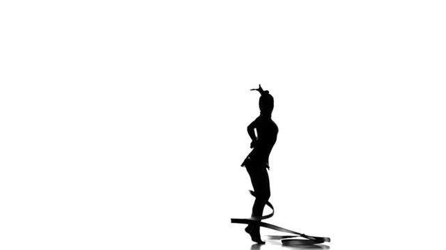 Silhouettes Artistic gymnast performing, slow motion