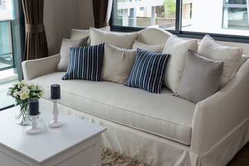 modern living room with row of pillows on sofa at home