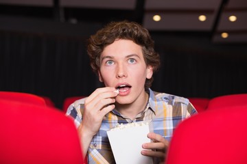 Young man watching a film
