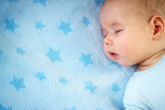 3 Month Old Baby Sleeping On Blue Blanket