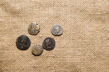Antique coins with portraits of emperors are on sacking