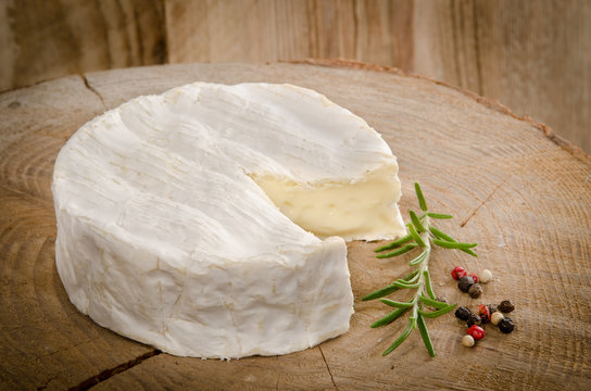 camembert on wood with rosemary