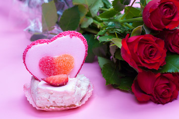 Valentine's day cake and roses on a pink background