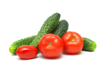 Ripe red tomatoes and cucumbers isolated on white background