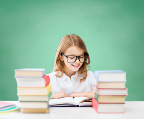 happy student girl reading book at school