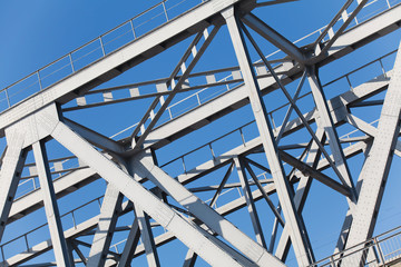 Construction truss bridge on background of blue sky