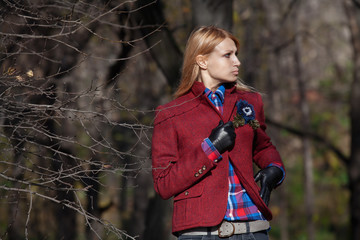 Beautiful blonde woman in tweed jacket and leather gloves in aut