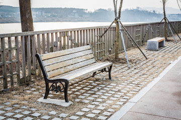 Fototapeta na wymiar Vintage bench at the river