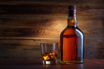 Bottle of whiskey on a wooden background