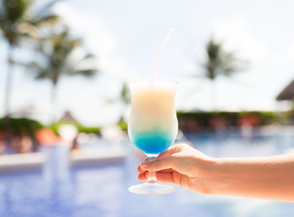 close-up of hand holding glass with cocktail