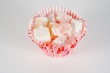 Turkish Delight in tins on a white background.