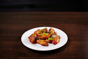 Chicken wings on white dish with beer