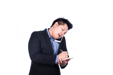 Asian business man on phone and taking notes