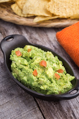 Chunky homemade guacamole in cast iron dish