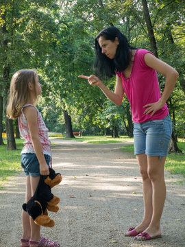 Mother scolding little girl in the park