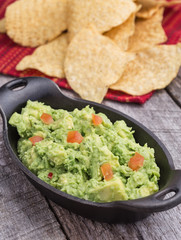 Chunky homemade guacamole in cast iron dish