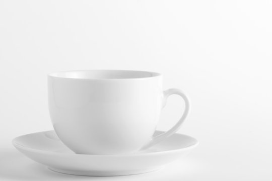 White cup and saucer on a white background