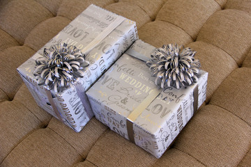 Two gifts wrapped for a wedding celebration