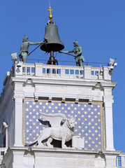 venice famous clock tower with blackened statues from the elemen