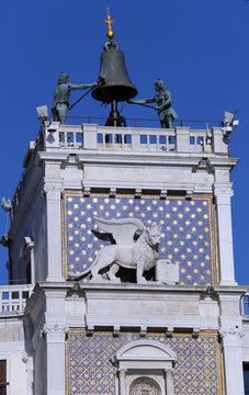 venice clock tower with blackened statues and lion