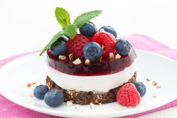 delicious cake with fruit jelly, nuts and fresh berries