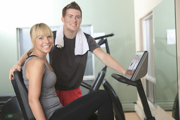Young athletic couple in gym on training