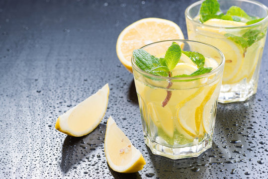 Fresh lemonade with mint on a dark background, close-up