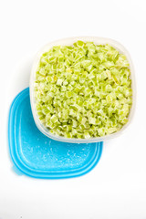 cut celery. frozen vegetables in plastic box