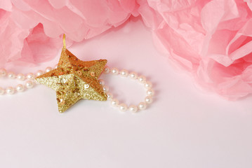 Decorative star, pearl beads and pink pom pom.