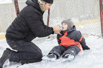 A family playing at the skating rink in winter.