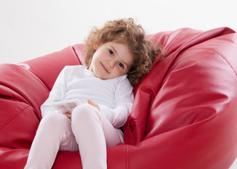 the child sitting on the furniture frame less isolated on white