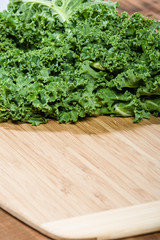 Green curly kale on cutting board