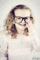 Smiling little girl with glasses