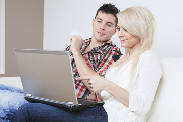 A Couple on sofa with laptop who want to buy something on the In