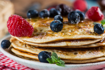 Delicious summer breakfast with fresh berries fruits and sirup