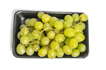 green grape in black styrofoam with isolated white background