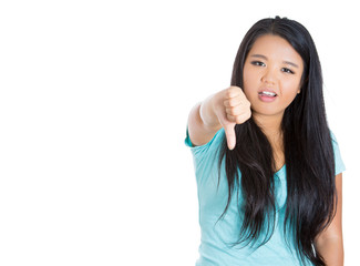 Unhappy woman giving thumbs down gesture looking displeased 