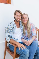 Attractive couple sitting on bench