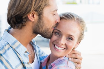 Fototapeta premium Attractive couple standing and hugging