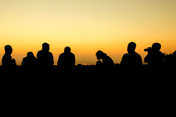 Fototapeta na wymiar silhouette of group of friends standing in sunset