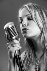 Blond singing with vintage microphone