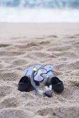 snorkel equipment on a rocky beach