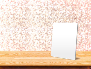 White paper frame at marble Table with bokeh sparkling backgroun