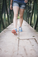 young tourist in the mountains with his arms raised
