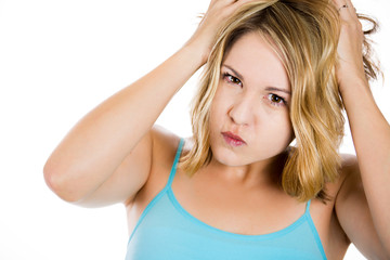 Fototapeta premium Frustrated stressed young woman pulling her hair out
