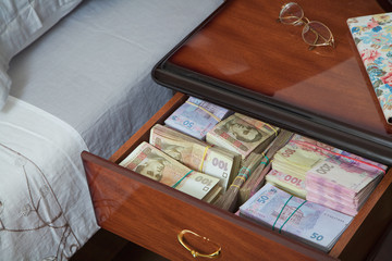 Bundles of banknotes in bedside table